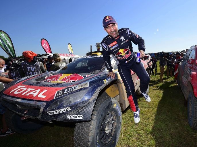 12108 - ROSARIO, -, ARGENTINA : Peugeot's French driver Stephane Peterhansel jumps after the Stage 13 of the Rally Dakar 2016 between Villa Carlos Paz and Rosario, Argentina, on January 16, 2016. Peugeot's driver Stephane Peterhansel won the Dakar Rally car title ahead of Mini's driver Nasser Al-Attiyah of Qatar and Toyota's driver Giniel De Villiers of South Africa. AFP PHOTO / FRANCK FIFE
