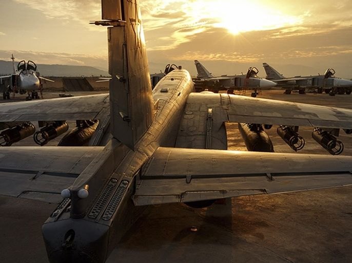 This handout photo taken on Friday, Dec. 18, 2015 provided by the Russian Defense Press Service, shows a Russian Su-25 ground attack jet is parked at the Hemeimeem air base in Syria, with Su-24 bombers seen in the background. Russia has been carrying out an air campaign in Syria since Sept. 30. (Vadim Savitsky/Russian Defense Ministry Press Service via AP)