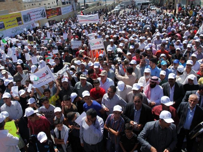 Palestinian refugee students and UNRWA workers hold banners and shout slogans against UNRWA in front of the United Nations Relief and Works Agency (UNRWA) School in Wehdat refugee camp in Amman, Jordan, 12 August 2015. According to reports thousands of Palestinian students, teachers and workers gathered to protest the reduction of services to Palestinian refugees in Jordan, where some 200,000 Palestinian refugees from 14 refugee camps in Jordan are enrolled in schools. However, due to huge demands on the UN refugee agencies asa result of unrest in the region, UNRWA finds itself chronically underfunded by its international donors, and forced to consider massive cuts throughout its activities in Jordan, Syria and Lebanon.
