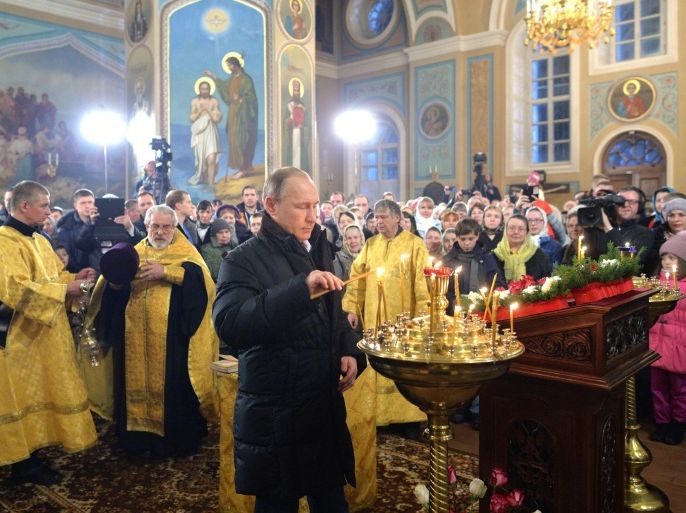 Russian President Vladimir Putin, center, attends midnight Orthodox Christmas Mass in a church in the village of Turginovo, about 150 kilometers (90 miles) northwest of Turginovo, Russia, late Wednesday, Jan. 6, 2016. Russian news reports said the church was where his parents had been baptized. The Russian Orthodox Church observes Christmas on Jan. 7 as it retained the Julian calendar. (Alexei Druzhinin, Sputnik, Kremlin Pool Photo via AP)