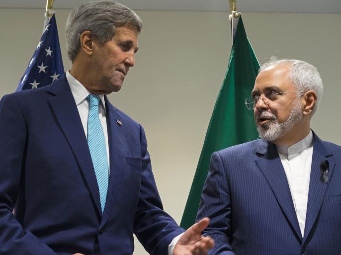 FILE - In this Sept. 26, 2015 file photo, Secretary of State John Kerry meets with Iranian Foreign Minister Mohammad Javad Zarif at United Nations headquarters. As Iran races to satisfy the terms of last summer’s nuclear deal and the U.S. prepares to suspend sanctions on Tehran as early as Friday, Kerry is talking to Zarif more than any other foreign leader, including an emergency call Tuesday to secure the release of 10 U.S. sailors after they were detained by Iran in the Persian Gulf. (AP Photo/Craig Ruttle, File)