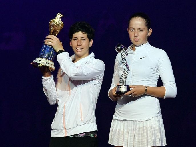 Winner Carla Suarez Navarro (L) of Spain celebrates next to runner up Jelena Ostapenko of Latvia during their final match of the WTA Qatar Ladies Open at the International Khalifa Tennis Complex Doha, Qatar on 27 February 2016.