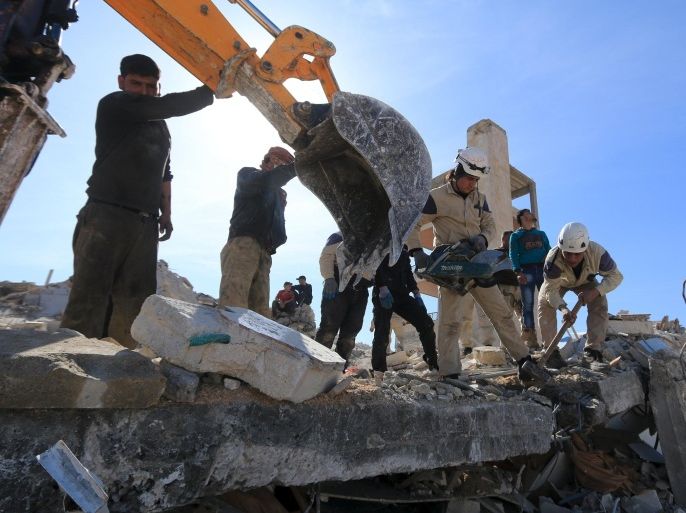People and Civil Defense members remove rubble while looking for survivors in the ruins of a destroyed Medecins Sans Frontieres (MSF) supported hospital hit by missiles in Marat Numan, Idlib province, Syria, February 16, 2016. REUTERS/Ammar Abdullah