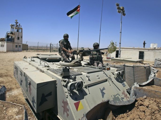 Jordanian soldiers stands guard in Mafraq, Jordan, near the northern Jordan-Syrian border, Sunday, Aug. 16, 2015. During an interview with The Associated Press, the commander of Jordan’s Border Police, Brig. Gen. Saber al-Mahayreh, said militants have tried to sneak into Jordan from Syria by blending in with Syrian refugees, and attempts to smuggle weapons and drugs into Jordan have increased. (AP Photo/Raad Adayleh)