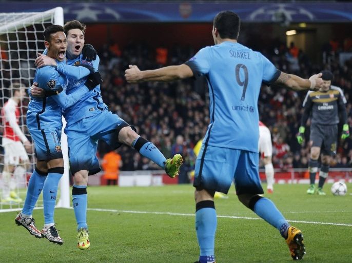 Barcelona players Neymar, left, and Luis Suarez celebrate after Lionel Messi, centre, scored the opening goal during the soccer Champions League round of 16 first leg soccer match between Arsenal and Barcelona at the Emirates stadium in London, Tuesday, Feb. 23, 2016. (AP Photo/Frank Augstein)