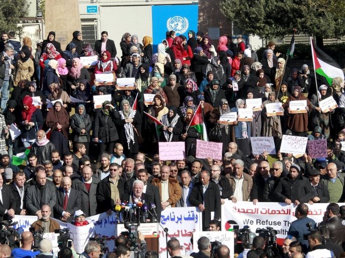 Palestinians living in Lebanon carry signs during a sit-in asking the United Nations Relief and Works Agency for Palestine Refugees in the Near East (UNRWA) for help in improving their living conditions, in front of the U.N. headquarters offices in Beirut, Lebanon January 29, 2016. REUTERS/Aziz Taher