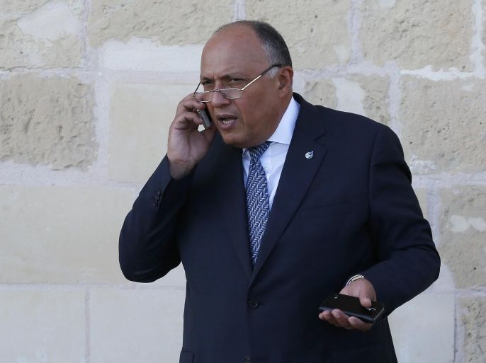 Egypt's Foreign affairs Minister Sameh Hassan Shoukry talks on cell phone during break of a summit on migration held in Valletta, Malta, Thursday, Nov. 12, 2015. (AP Photo/Antonio Calanni)