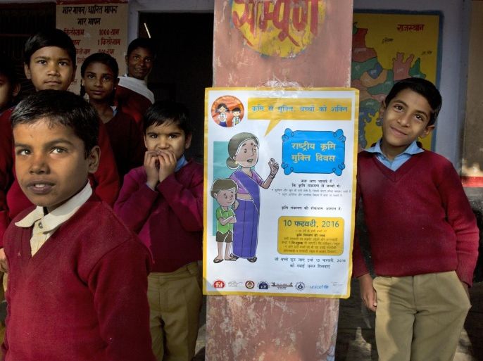 Students gather around a poster of deworming at their school in Neemrana, 123 kilometers (76.8 miles) from New Delhi, in the Indian state of Rajasthan, Wednesday, Feb. 10, 2016. Millions of Indian children are taking part in a massive national deworming campaign to prevent parasitic worms from infecting their bodies and impairing their mental and physical development. The campaign is targeting 270 million children across the country with a second treatment planned next week for those left out on Wednesday, India’s Health Ministry said in a statement. (AP Photo/Manish Swarup)