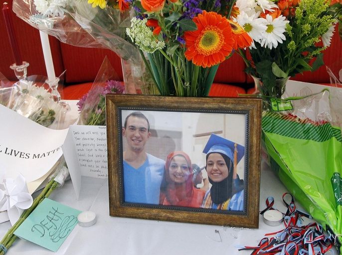 A makeshift memorial appears on display, Wednesday, Feb. 11, 2015, at the University of North Carolina School of Dentistry in Chapel Hill, N.C., in remembrance of Deah Shaddy Barakat, 23, Yusor Mohammad, 21, and Razan Mohammad Abu-Salha, 19, who were killed on Tuesday. Craig Stephen Hicks, 46, has been charged with three counts of first-degree murder in the case. (AP Photo/The News & Observer, Chris Seward) MANDATORY CREDIT, TV OUT