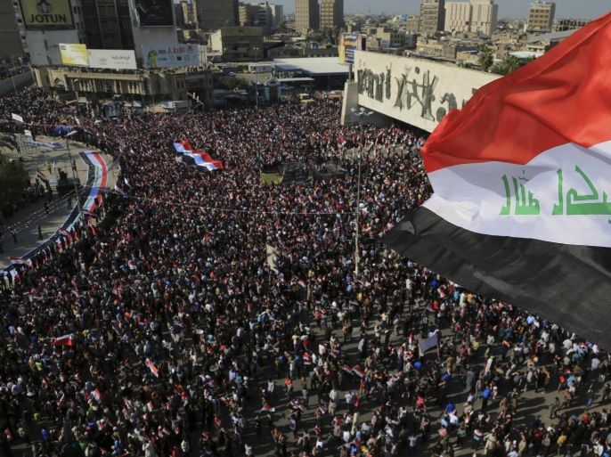 Followers of Iraq's influential Shiite cleric Muqtada al-Sadr chant slogans demand government reform as they wave Iraqi flags during a demonstration in Tahrir Square in Baghdad, Iraq, Friday, March 11, 2016. (AP Photo/Karim Kadim)