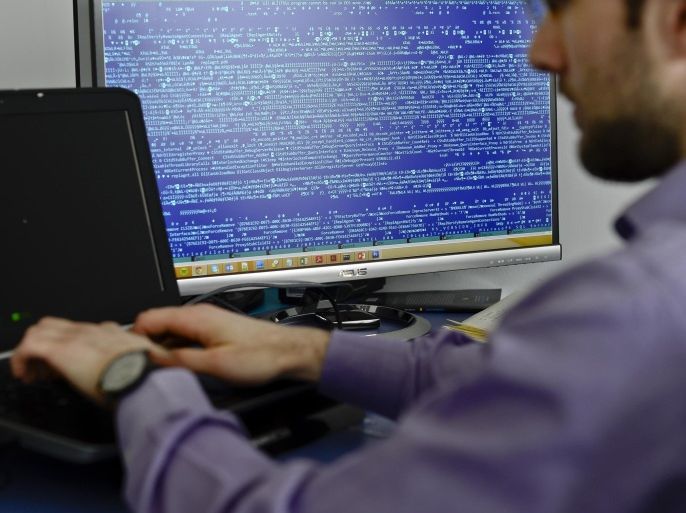 In this picture taken on March 5, 2015, an employee works at the headquarters of Bitdefender, a leading Romanian cyber security company, in Bucharest, Romania. Romania, the eastern European country, known more for economic disarray than technological prowess, has become one of the leading nations in Europe in the fight against hacking. The reason: the country’s own battle against Internet renegades and a legacy of computing excellence stemming from Communist dictator Nicolae Ceausescu’s regime. (Octav Ganea/ Mediafax via AP) ROMANIA OUT
