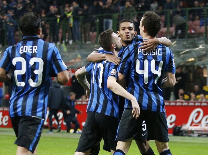 Inter Milan’s Ivan Perisic, right, celebrates with his teammates Citadin Martins Eder, left, Marcelo Brozovic, second from left, and Juan Jesus after scoring during the Serie A soccer match between Inter Milan and Bologna at the San Siro stadium in Milan, Italy, Saturday, March 12, 2016. (AP Photo/Antonio Calanni)