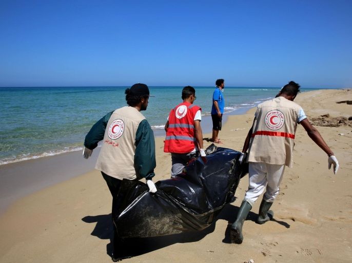 Libyan Red Crescent workers recover a body of a drowned migrant, off the shore of Gasr Garabulli, in the eastern city of Tripoli, Tuesday, March 29, 2016. Libyan Red Crescent workers collected 17 bodies since March 18 after a boat sank off the east coast of the city of Tripoli. (AP Photo/Mohamed Ben Khalifa)