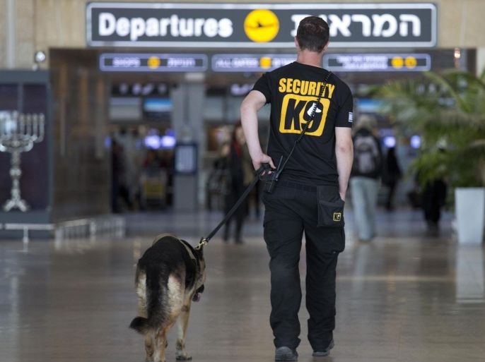 An Israeli airport security guard patrols with a dog in Ben Gurion airport near Tel Aviv, Israel, Tuesday, March 22, 2016. After the Brussels attacks, Israel briefly announced that all Israeli flights from Europe were canceled, then reinstated the flights, Israel Airports Authority spokesman Ofer Leffler said. Pini Schiff, former director of security at Ben-Gurion Airport, said the attack in the Brussels airport was “a colossal failure” of Belgian security, and he said “the chances are very low” that such a bombing could take place in Israel’s airport. Israel's Ben-Gurion Airport is considered among the most secure in the world, an outcome stemming from several Palestinian attacks on Israeli planes and travelers in the 1970s. (AP Photo/Ariel Schalit)
