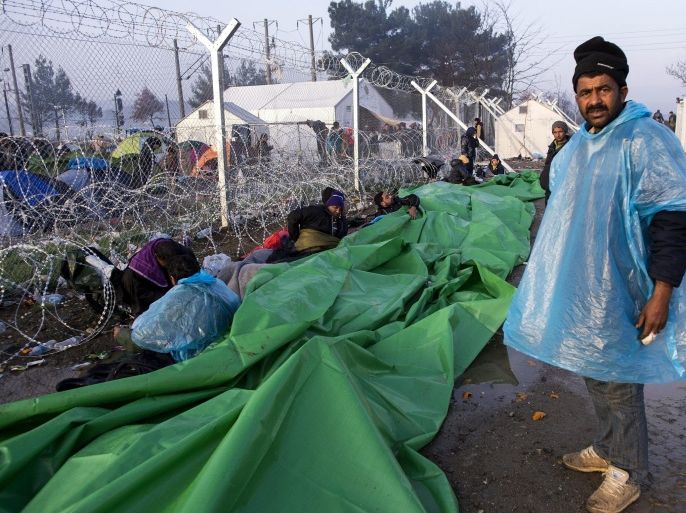 Refugees wake up next to the fence on the Macedonian side of the border as they wait to go back to Greece, near Gevgelija, The Former Yugoslav Republic of Macedonia, 01 March 2016. Macedonian police fired tear gas at hundreds of migrants after they stormed a metal fence along the border with Greece on 29 February, as refugees were blocked from traveling between the two countries on the main route to Western Europe. Migration restrictions along the so-called Balkan route, the main path for migrants from Greece to other EU countries, has left thousands stranded at the border between Greece and neighboring Macedonia.