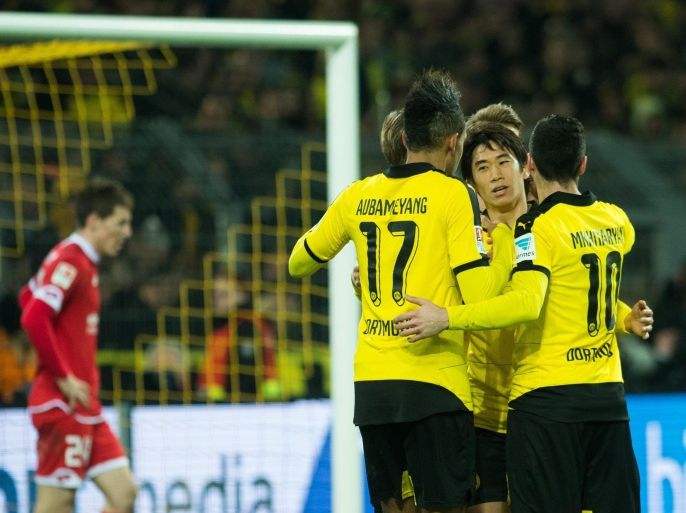 Dortmund's Shinji Kagawa (2.f.R) celebrates his 2-0 goal with Pierre-Emerick Aubameyang and Henrikh Mkhitaryan (R) during the German Bundesliga soccer match between Borussia Dortmunand FSV Mainz 05 in Signal Iduna Park in Dortmund, Germany, 13 March 2016. (EMBARGO CONDITIONS - ATTENTION - Due to the accreditation guidelines, the DFL only permits the publication and utilisation of up to 15 pictures per match on the internet and in online media during the match)
