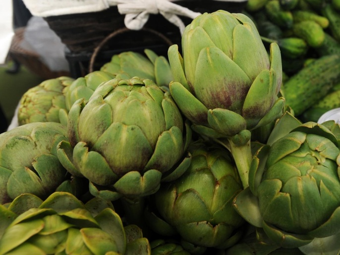 This Sept. 4, 2013 file photo shows artichokes and other vegetables for sale at the Kenley's Alaskan Vegetables and Flowers stand at the South Anchorage Farmers Market in Anchorage, Alaska. Billed as Alaska's largest open air market, it's a must-stop for tourists in town on Saturdays and Sundays. Located in a parking lot caddy-corner to the Hilton Hotel, the market offers music, food for purchase and Alaska vendors pedaling their wares. (AP Photo/Anchorage Daily News, Erik Hill) LOCAL TV OUT (KTUU-TV, KTVA-TV) LOCAL PRINT OUT (THE ACHORAGE PRESS, THE ALASKA DISPATCH)