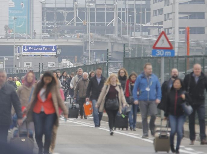 Passengers are evacuated from the terminal building after explosions at Brussels Airport in Zaventem near Brussels, Belgium, 22 March 2016. Dozens of people have died or been injured in a double blast in the departure hall of Zaventem Airport in Brussels, Belgian media reported.