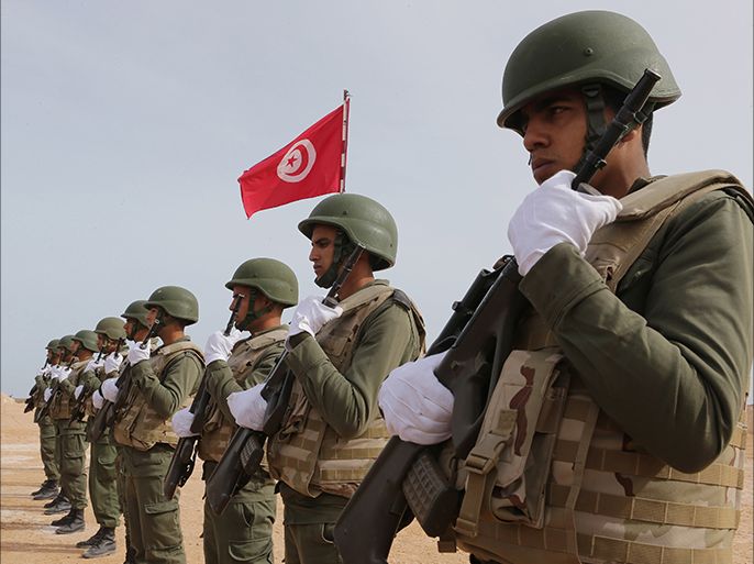 epa05147067 Tunisian soldiers pose during a presentation of the anti-jihadi fence, in near Ben Guerdane, eastern Tunisia, close to the border with Libya, 06 February 2016. Tunisian Defense Minister Farhat Horchani inspected the first completed part of the 196-kilometer ditch, which aims to render the entire border impassable by vehicles. EPA/MOHAMED MESSARA