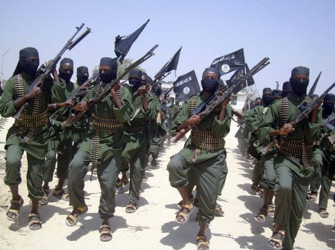 FILE - In this Thursday, Feb. 17, 2011 file photo, al-Shabab fighters march with their weapons during military exercises on the outskirts of Mogadishu, Somalia. A U.S. drone strike in Somalia has targeted a key leader of the al-Shabab militant group who was involved in two attacks in Mogadishu more than a year ago that killed more than 30 people, at least three Americans among them, the Pentagon said Friday, April 1, 2016. Several U.S. officials said he and two others were killed. Hassan Ali Dhoore was targeted in the airstrike Thursday, but the U.S. military was still assessing the results, Pentagon spokesman Peter Cook said in a statement. (AP Photo/Mohamed Sheikh Nor, File)