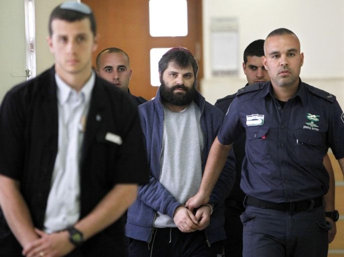 Yosef Haim Ben David, center, suspected of the killing of Palestinian Mohammed Abu Khdeir arrives to a court in Jerusalem, Tuesday, March 22, 2016. (AP Photo/Mahmoud Illean)