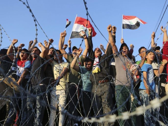 Followers of Shiite cleric Muqtada al-Sadr chant slogans as they ending their sit-in outside the heavily guarded Green Zone in Baghdad, Iraq, Thursday, March 31, 2016. Thursday evening al-Sadr called on his supporters to end their sit-in, but to continue "peaceful protests in all Iraqi provinces every Friday to put pressure on lawmakers to vote on the new Cabinet." In a televised speech from his tent erected inside the Green Zone, al-Sadr warned that if the parliament failed to vote, he would pull out his ministers from the Cabinet and call for a vote of no confidence in al-Abadi's government. (AP Photo/Khalid Mohammed)