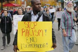 Khaled Esseissah carries a sign while marching against Islamophobia in Bloomington, Ind., Friday, Oct. 23, 2015. The march let to a rally at the Monroe County Courthouse in response to the Oct. 17 attack in which an Indiana University student shouted racial slurs and tried to remove a Muslim woman's headscarf. (Jeremy Hogan/The Bloomington Herald-Times via AP)