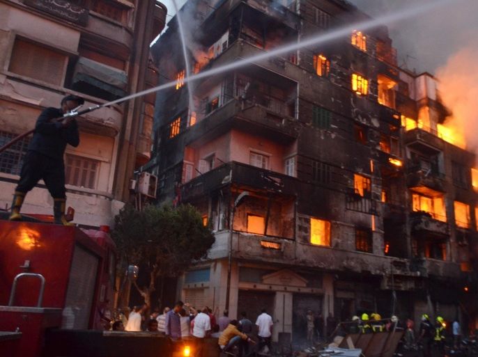 Egyptian firefighters try to extinguish a fire that engulfed several buildings in Cairo, Egypt, 09 May 2016. According to reports, 50 people were injured, including firefighters, when an overnight fire at a small hotel in Ataba neighborhood spread to other buildings and markets in the old area of Cairo. EPA/AYMAN AREF EGYPT OUT