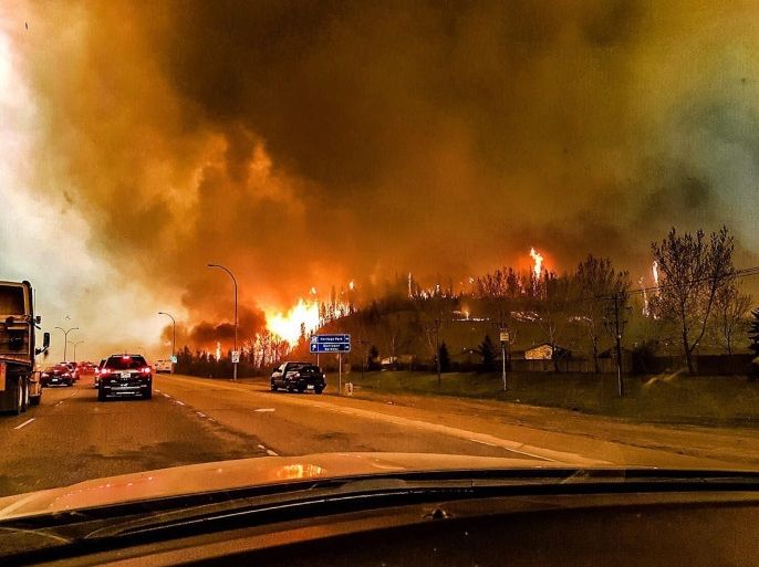 A picture provided by Twitter user @jeromegarot on 05 May 2016 shows a wildfire raging through the town of Fort McMurray, Canada, 03 May 2016. Weather conditions were making it more difficult to extinguish a forest fire that has forced the evacuation of some 70,000 people from the northwestern Canadian city of Fort McMurray. Alberta provincial authorities estimated that at least some 1,600 buildings in the city have been consumed by the flames, which have not caused any deaths or injuries so far. EPA/TWITTER.COM/JEROMEGAROT ATTENTION EDITORS : EPA IS USING AN IMAGE FROM AN ALTERNATIVE SOURCE AND CANNOT PROVIDE CONFIRMATION OF CONTENT, AUTHENTICITY, PLACE, DATE AND SOURCE. EDITORIAL USE ONLY/NO SALES