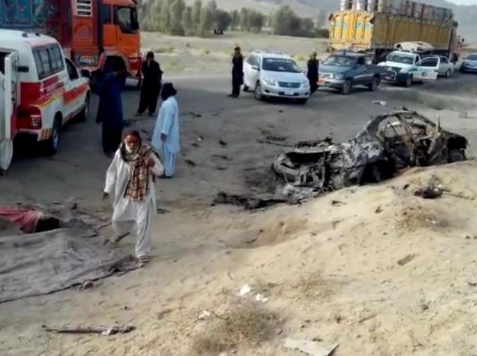 A frame grab from a video made available on 22 May 2016 shows people gather next to an ambulance at the alleged scene of a drone strike site that killed Taliban's supreme leader Mullah Akhtar Mansoor, in the Ahmad Wal area of Balochistan in Pakistan. Dawlat Waziri, Afgan Defense Ministry spokesman confirmed to the reporters that Taliban's supreme leader Mullah Akhtar Mansoor was killed in Balochistan province of Pakistan. Mullah Akhtar Mansoor took over the command of Taliban after the reports of Taliban's supreme leader Mullah Omar's death.