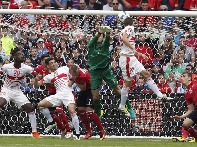 Switzerland's Fabian Schaer (2-R) scores the opening goal past Albania goalkeeper Etrit Berisha (C) during the UEFA EURO 2016 group A preliminary round match between Albania and Switzerland at Stade Bollaert-Delelis in Lens Agglomeration, France, 11 June 2016.(RESTRICTIONS APPLY: For editorial news reporting purposes only. Not used for commercial or marketing purposes without prior written approval of UEFA. Images must appear as still images and must not emulate match action video footage. Photographs published in online publications (whether via the Internet or otherwise) shall have an interval of at least 20 seconds between the posting.) EPA/LAURENT DUBRULE