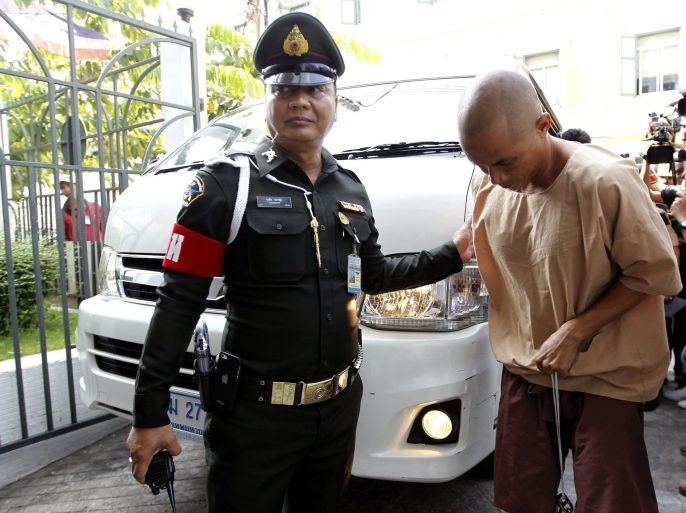 An unidentified Thai citizen, one of the eight who were detained after allegedly posting messages criticizing the Thailand's Prime Minister Prayut Chan-o-cha on Facebook, is escorted by a military police officer as he arrives to the military court for trial in Bangkok, Thailand, 10 May 2016. Human rights activists expressed growing concerns after Prayut's crackdown on pro-democracy activists with sedition and other criminal charges. Eight people were detained with sedition charges allegedly violating the Computer Crimes Act after posting messages criticizing the Thai Prime Minister on Facebook.