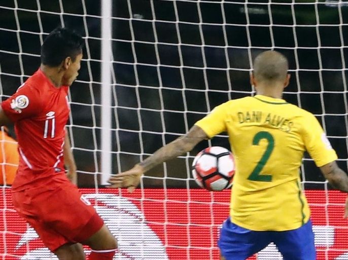 Jun 12, 2016; Foxborough, MA, USA; Peru forward Raul Ruidiaz (11) scores on Brazil goalkeeper Alisson Becker (1) as Brazil defender Daniel Alves (2) looks on during the second half of Peru's 1-0 win over Brazil in the group play stage of the 2016 Copa America Centenario. at Gillette Stadium. Mandatory Credit: Winslow Townson-USA TODAY Sports