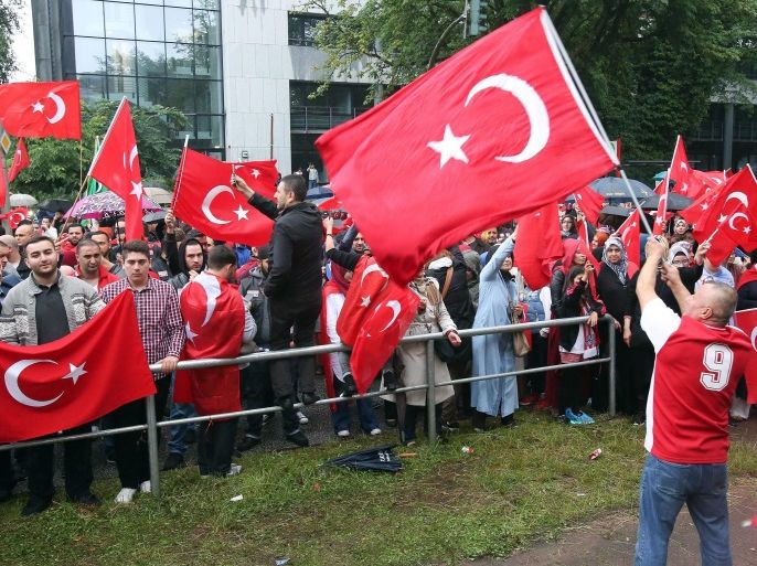 Protesters with Turkish flags at a demonstration against the failed attempted coup in Turkey, outside the  the Turkish consulate general in Hamburg, Germany, 16 July 2016. Turkish Prime Minister Yildirim reportedly said that the Turkish military was involved in an attempted coup d'etat. The Turkish military meanwhile stated it had taken over control. According to news reports, Turkish President Recep Tayyip Erdogan has denounced the coup attempt as an 'act of treason' and insisted his government remains in charge. Some 104 coup plotters were killed, 90 people - 41 of them police and 47 are civilians - 'fell martrys', after an attempt to bring down the Turkish government, the acting army chief General Umit Dundar said in a televised appearance.