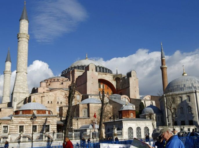 A tourist couple checks a map, near the Byzantine-era monument of Hagia Sophia, at Sultanahmet square in Istanbul,Turkey January 14, 2016. REUTERS/Murad Sezer