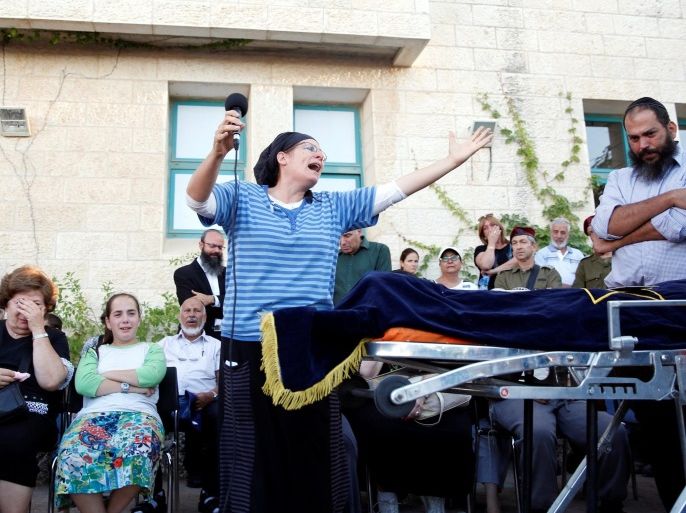 The mother of Israeli girl, Hallel Yaffa Ariel, 13, who was killed in a Palestinian stabbing attack in her home in the West Bank Jewish settlement of Kiryat Arba, mourns during her funeral at a cemetery in the West Bank city of Hebron June 30, 2016. REUTERS/Ronen Zvulun