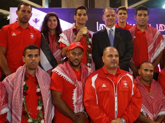 Prince Faisal Bin Al Hussein, President of the Jordanian Olympic Committee (top C), poses with of Ahmad Abughaush, who won a Taekwondo gold claiming Jordan's first ever Olympic medal, and the members of the Jordanian mission for the Olympics after their arrival at the Queen Alia International Airport in Amman, Jordan, August 23, 2016. REUTERS/Muhammad Hamed