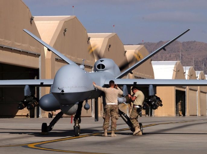 U.S. airmen prepare a U.S. Air Force MQ-9 Reaper drone as it leaves on a mission at Kandahar Air Field, Afghanistan March 9, 2016. Picture taken March 9, 2016. REUTERS/Josh Smith