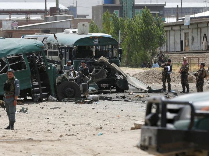 Afghan security forces inspect the damage on buses hit by suicide bombers at the site of an attack on the western outskirts of Kabul, Afghanistan June 30, 2016. REUTERS/Omar Sobhani