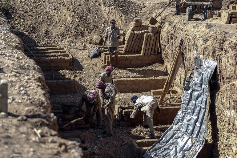 epa05496216 Workers dig the multi-layered graveyard of Douma city, outskirts of Damascus, Syria, 18 August 2016. The Local Council of Douma started digging multi-layered graves as a solution for the massacre that happened in August of 2015 when more than 100 Syrian were killed in airstrikes on the Rebel-held city of Douma, 60 people were buried in two mass graves in that night. The graveyard always contains at least 40 empty graves in case of mass killing. The graves contains eight stairs, and is organized to bury the unknown on top in case they were identified later.  EPA/MOHAMMED BADRA