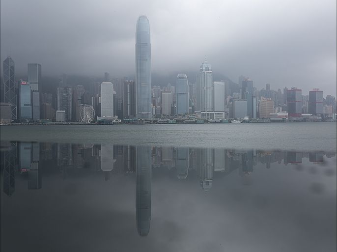 epa05451539 The Hong Kong island skyline is reflected in a metallic panel during typhoon Nida in Hong Kong, China, 02 August 2016. Nida is the first major typhoon to shut down Hong Kong this year. Classes at all schools are suspended for the day, ferries to and between outlying islands are also suspended as well as tram service on Hong Kong Island. EPA/JEROME FAVRE