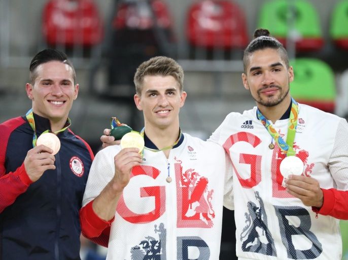 Bronze medalist Alexander Naddour of USA (L-R), Gold medalist Max Whitlock of Great Britain, and silver medalist Louis Smith of Great Britain (R) smile on the podium during the medal ceremony for the men's Pommel Horse Final competition of the Rio 2016 Olympic Games Artistic Gymnastics events at the Rio Olympic Arena in Barra da Tijuca, Rio de Janeiro, Brazil, 14 August 2016.