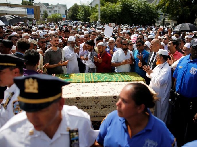 Community members pray next to the coffins during the funeral service of Imam Maulama Akonjee, and Thara Uddin in the Queens borough of New York City, August 15, 2016. REUTERS/Eduardo Munoz