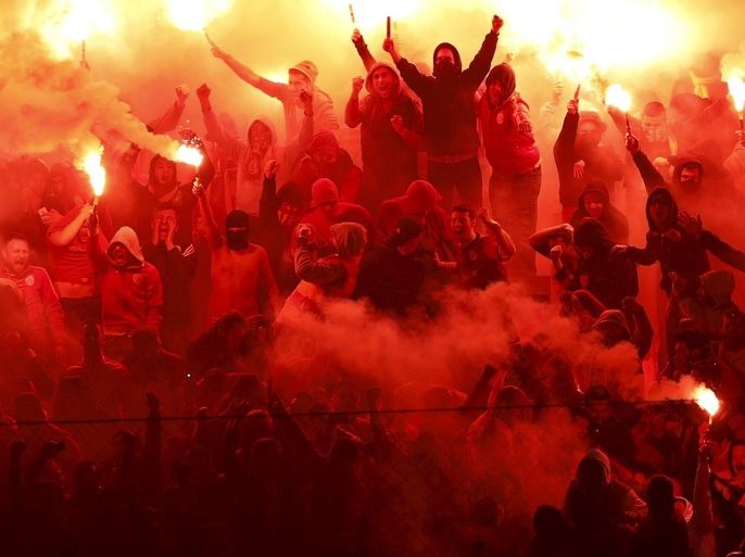 Galatasaray fans light flares to celebrate their goal against Fenerbahce during the Turkish Super League derby soccer match between Galatasaray and Fenerbahce in Istanbul, Turkey in this April 6, 2014 file photo. Ambitions to secure a place at international soccer's top table have come at a high cost for Turkey's leading clubs, which are now struggling to navigate a sea of debt after years of heavy spending. REUTERS/Murad Sezer/Files