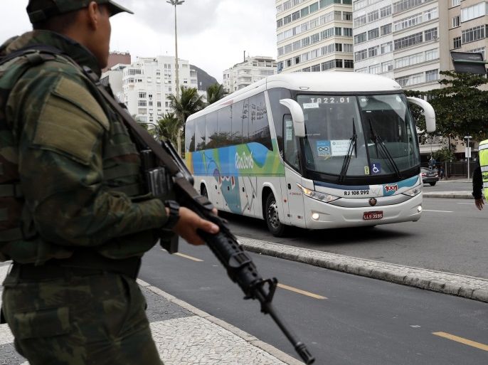 Brazilian armed police patrol a Rio Olympic bus stop on Copacabana boulevard which transports athletes and media to the Olympic Beach Volleyball Arena venue in the Rio 2016 Olympic Games in Rio de Janeiro, Brazil, 10 August 2016. An official bus carry media came under fire on 09 August 2o16 according to reports.