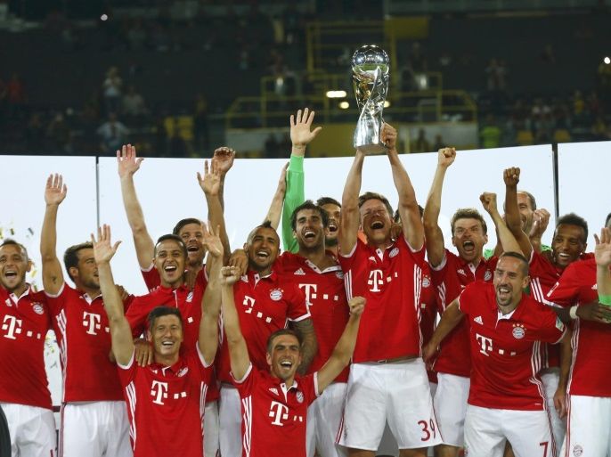 Football Soccer - Borussia Dortmund v Bayern Munich - German Supercup - Signal Iduna Park, Dortmund, Germany - 14/8/16 Players of the team Bayern Munich with the cup celebrate wictory . REUTERS/Ralph Orlowski DFL RULES TO LIMIT THE ONLINE USAGE DURING MATCH TIME TO 15 PICTURES PER GAME. IMAGE SEQUENCES TO SIMULATE VIDEO IS NOT ALLOWED AT ANY TIME. FOR FURTHER QUERIES PLEASE CONTACT DFL DIRECTLY AT + 49 69 650050.