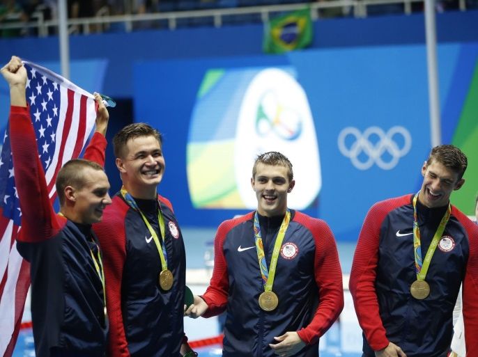Caeleb Dressel (L-R), Nathan Adrian, Ryan Held, and Michael Phelps of the USA pose with their gold medals after the medal ceremony for the men's 4x100m Freestyle relay final race of the Rio 2016 Olympic Games Swimming events at Olympic Aquatics Stadium at the Olympic Park in Rio de Janeiro, Brazil, 07 August 2016.