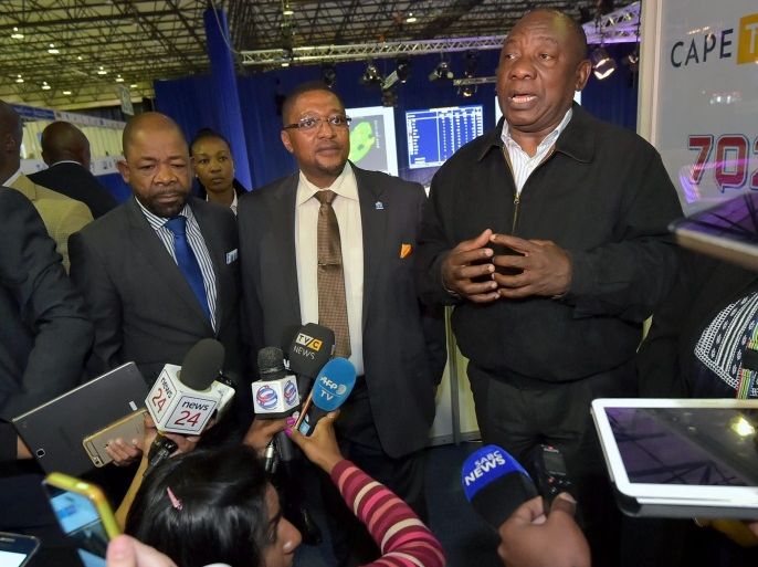 A handout photograph made available by the South African Government Communication and Information System (GCIS) shows South African Deputy President Cyril Ramaphosa (C) addressing the media at the ANC desk after the walk about at the IEC National Results Operation Centre in Pretoria, South Africa, 05 Agusut 2016. The ANC has lost the Nelson Mandela Bay area to the opposition party the DA and although the ANC still lead the polls nationally the DA has taken two major cit