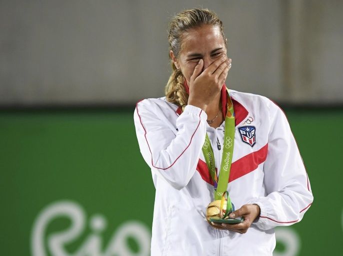 2016 Rio Olympics - Tennis - Victory Ceremony - Women's Singles Victory Ceremony - Olympic Tennis Centre - Rio de Janeiro, Brazil - 13/08/2016. Gold medalist Monica Puig (PUR) of Puerto Rico reacts after receiving her medal. REUTERS/Toby Melville FOR EDITORIAL USE ONLY. NOT FOR SALE FOR MARKETING OR ADVERTISING CAMPAIGNS.