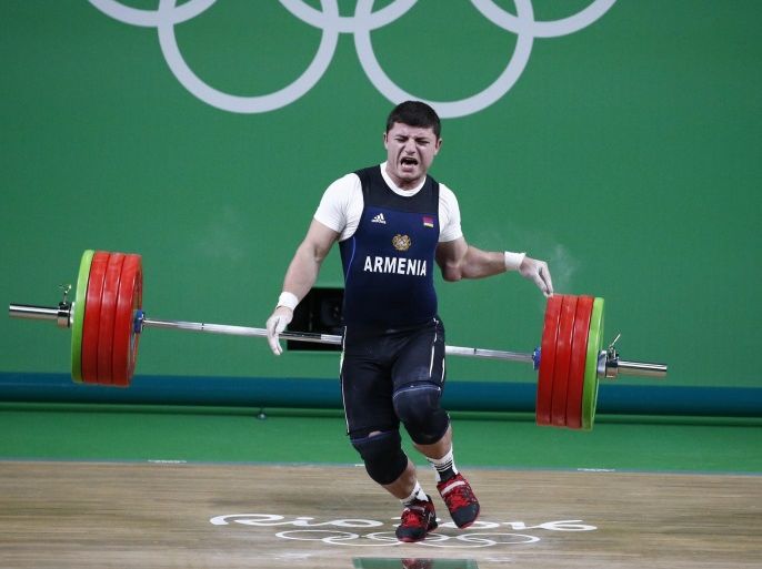 Andranik Karapetyan of Armenia releases the weights while injurying himself in the men's 77kg category of the Rio 2016 Olympic Games Weightlifting events at the Riocentro in Rio de Janeiro, Brazil, 10 August 2016.